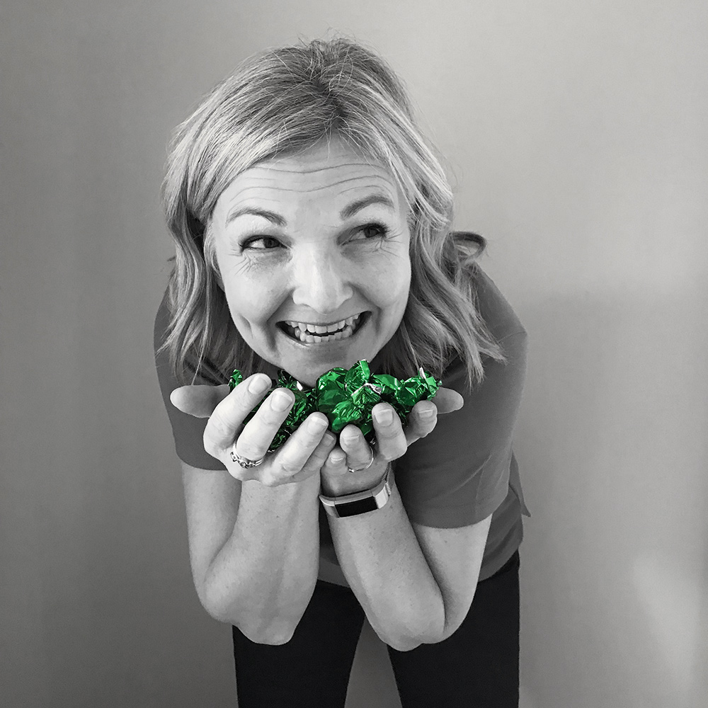 Helen, Co-founder & Operations Director Helen Hydraulics Online holding green sweets