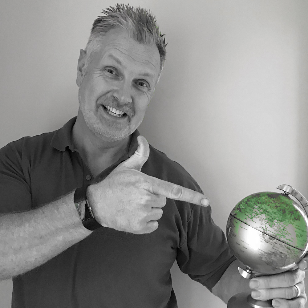 Mark, Co-founder & Managing Director Hydraulic Solutions Online pointing at globe