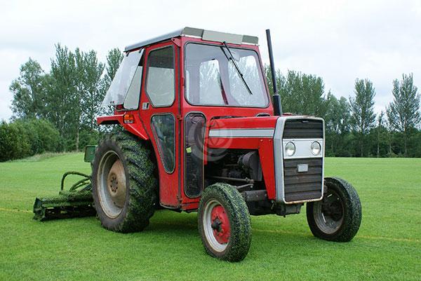 red tractor with gang mower